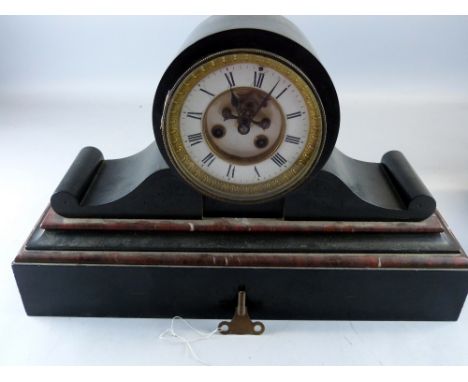 A 19th Century black slate and red marble mounted clock.  Architectural form.  Inlaid plinth.  Visible brocot escapement. 13 