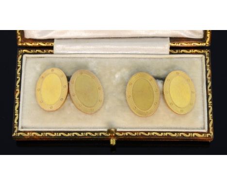A pair of gold cufflinks. oval with engraved decoration, 9ct gold, cased 