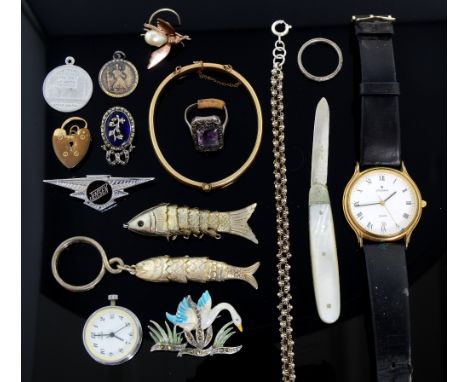 Collection of costume jewellery including Victorian enamel brooch, silver fish charms, and other items 