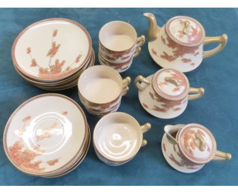 Japanese Satsuma tea service comprising six cups and saucers, tea pot, covered sugar and milk decorated with trailing flowers