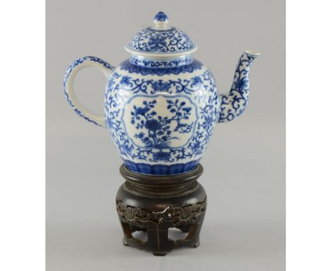 Chinese blue and white teapot and cover decorated with two panels of a flowering shrub with wind chimes and framed by styalis