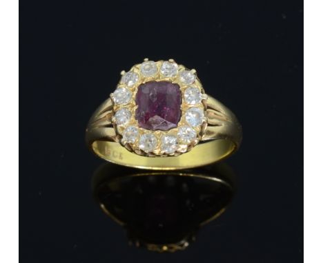 Victorian ruby and diamond set ring. central oval cushion cut stone within a border of diamonds, 18ct gold  