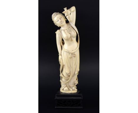 Late 19th century Chinese ivory carving of a maiden holding a flask in her left hand, 33cm high,