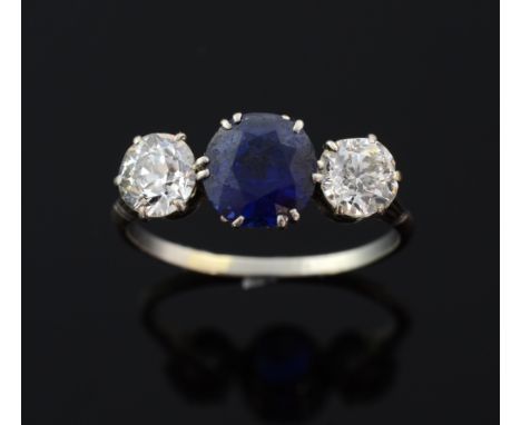 Sapphire and diamond three stone ring, sapphire to centre weighing approximately 1.95 of a deep blue colour, flanked by old-c