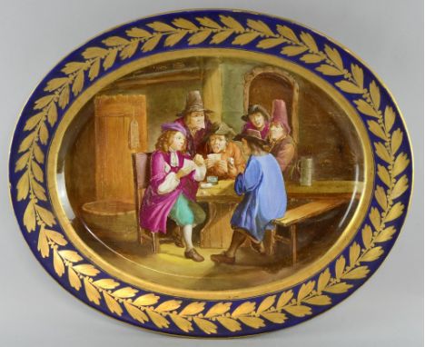 19th century oval plate, blue border highlighted in gilt, centre decorated with tavern scene of three men playing cards with 