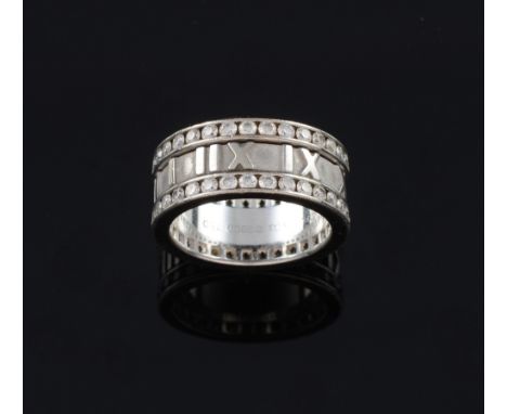 Tiffany & Co diamond Atlas ring, set with two rows of channel set diamonds with graphic Roman numerals on a matt background, 