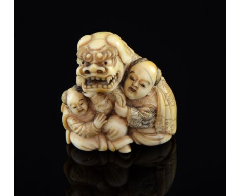 Carved Ivory Netsuke of 'The Lion festival Dog' with two attendants signed
