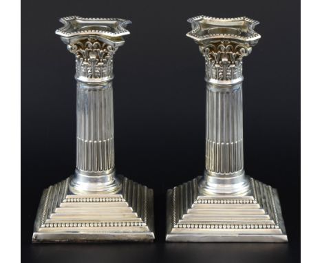 Pair of Edward VII silver candlesticks with beaded decoration on stepped bases, by Barker Brothers, Birmingham, loaded bases,
