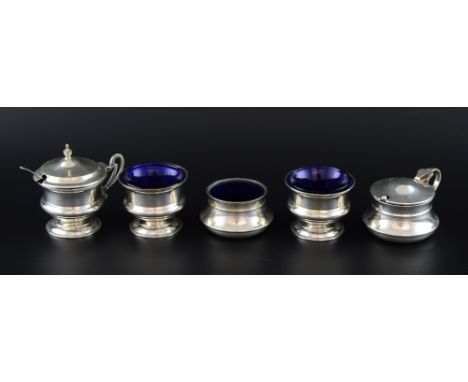 Five non-matching silver cruets comprising three salts, and two mustard pots and covers and two spoons,