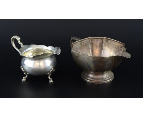 George V silver cream jug with wavy rim, scroll handle on hoof feet, by Haseler Brothers, Chester, 1911 and another cream jug