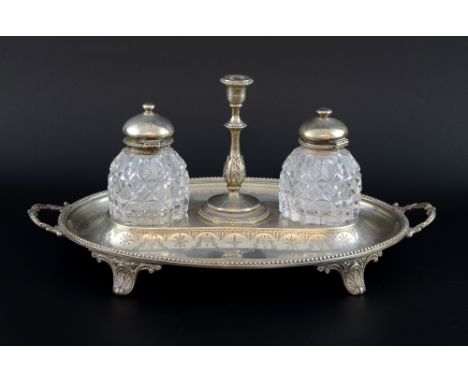 Victorian silver oval two handled desk stand with beaded border, engraved decoration, on four shaped feet, with two cut glass