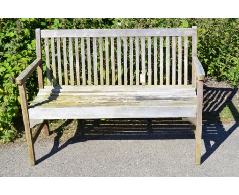 Teak garden bench with slat back supports. 120cm long