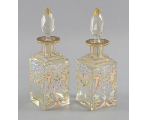 A fine pair of French enamelled scent bottles. painted with cherubs and floral garlands, the step cut necks with gilt highlig
