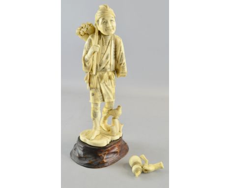 19th Century Japanese carved ivory figure of a man carrying an axe, on hardwood base.  30cm high.