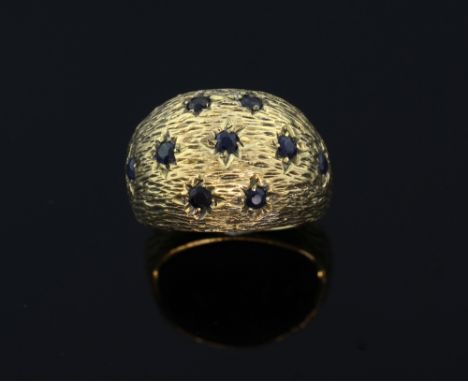 Sapphire and diamond  bombe style ring. set with nine sapphire on a gold textured background . Circa 1960's 