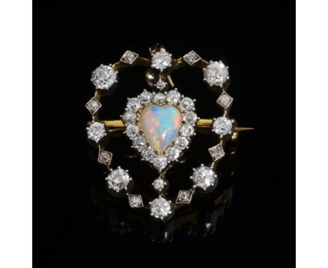 Late Victorian opal and diamond heart pendant brooch. Heart shape opal to centre within a old-cut diamond border and openwork