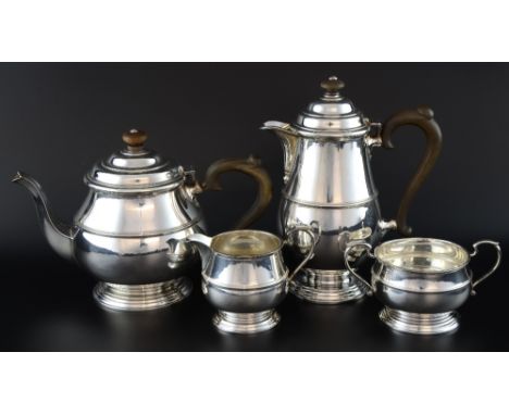 George VI silver four piece tea service, comprising teapot, hotwater jug, cream jug and sugar bowl, with plain banded decorat