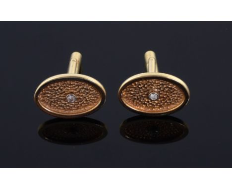 A pair of gold and diamond cufflinks. oval shape with a diamond set to the centre. Mounted in 14ct gold.  