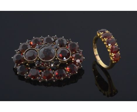 A Victorian brooch set with pyrope garnet. silver gilt and a five stone garnet ring mounted 18ct gold 