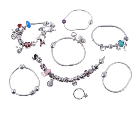  A collection of Pandora silver coloured charm bracelets,   suspending various charms, some signed Pandora; together with an 
