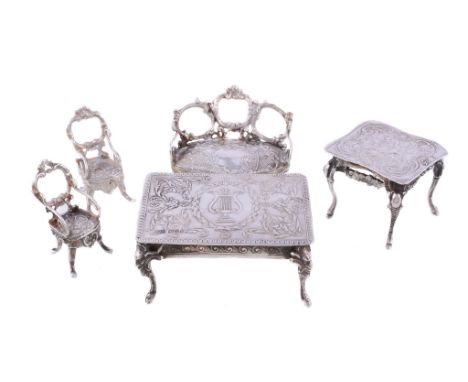  A collection of silver doll's house or toy furniture,   variously embossed, comprising: a table by Storck  &  Sinsheimer, Ha