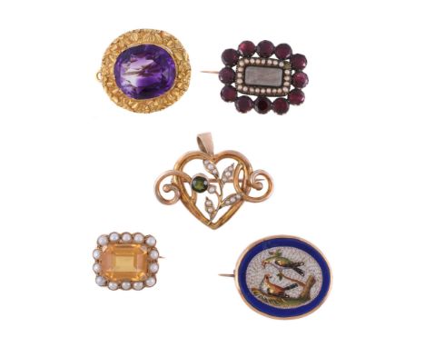  Four antique brooches,   the first a Victorian amethyst brooch, circa 1860, the oval cut amethyst within a gold floral setti