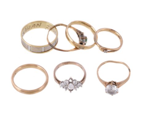  A small collection of rings  , to include a two colour band ring, stamped 585; two gold coloured band rings; a 9 carat gold 