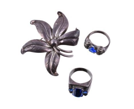  A 1940s French silver, paste and marcasite ring,   of tank style, set with a circular cut blue paste claw set between marcas