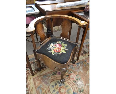 A George III mahogany corner commode chair with bow back, lift off tapestry seat and tapering legs with ball and claw feet, 7