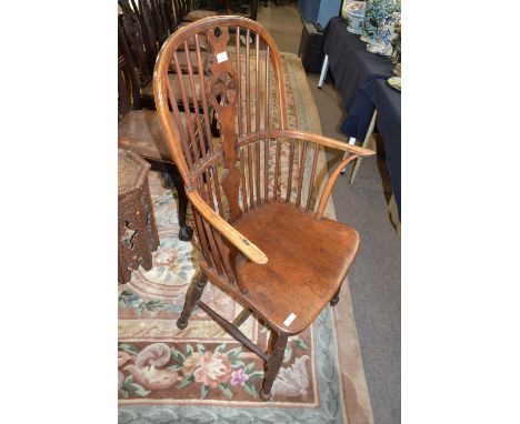A 19th Century stick back Windsor chair with central splat decorated with stylised fleur de lis design, raised on turned legs
