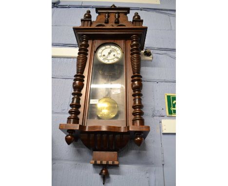 Late 19th Century Vienna style wall clock set in a walnut veneered architectural case, the white enamel dial to a brass movem