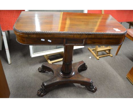 A mid 19th Century rosewood card table with folding top opening to a baize lined interior raised on a tapering circular colum