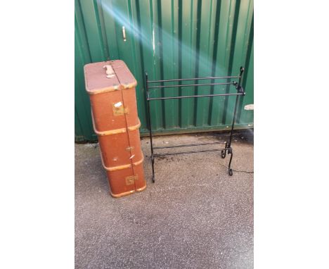 A vintage travelling trunk with metal black towel rail