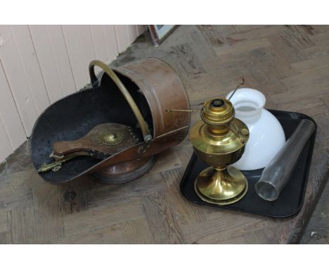 A copper coal scuttle, bellows and hearth brush plus a brass oil lamp with opaque glass shade