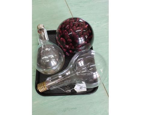 A very large amethyst glass dump/paperweight approx 6" dia together with two very large light bulbs