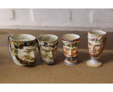 Four late 18th Century porcelain Bacchus face mask mugs, one pearl ware, one with carved frog (minor damage)