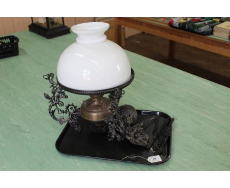 A Victorian cast iron hanging brass oil lamp with shade, maker marked