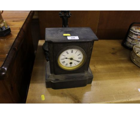 A black slate single hole mantel clock
