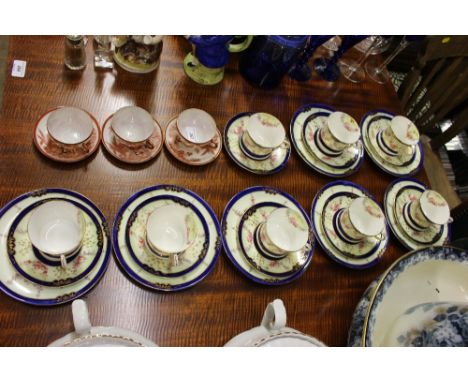 A quantity of floral decorated trios and three Japanese tea cups and saucers