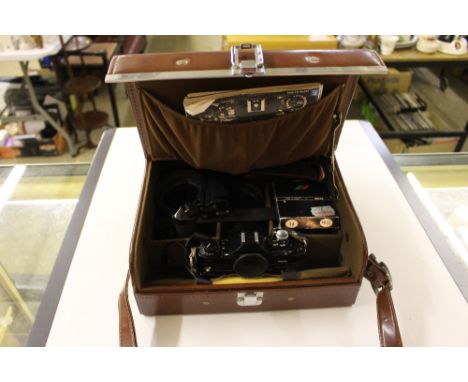 A leather case containing a Canon camera and accessories