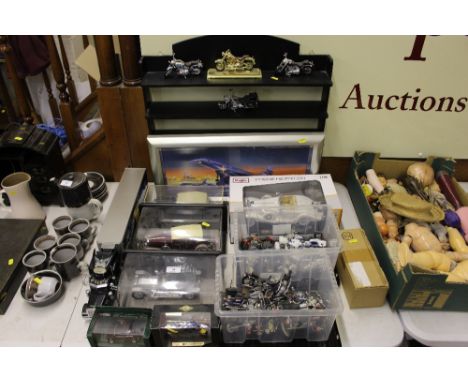 A quantity of model cars and motor bikes together with a rack and a print of a Concorde
