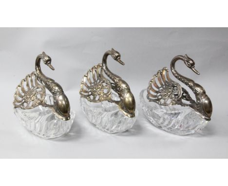 A matched set of three modern repousse silver mounted cut glass sweetmeat dishes modelled as swans, pair with import marks fo