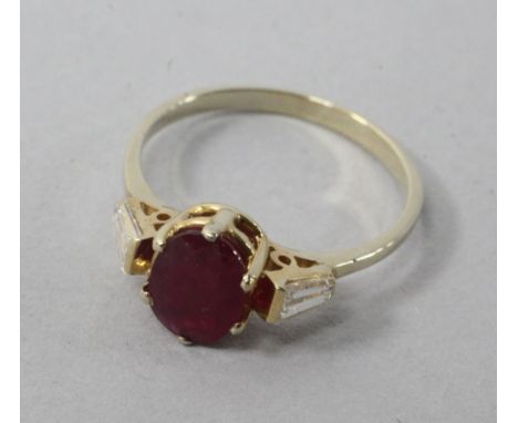 A 14ct and ruby ring with tapered cut diamond set shoulders, size L.