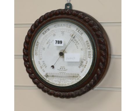 An Edwardian oak aneroid barometer W.28cm