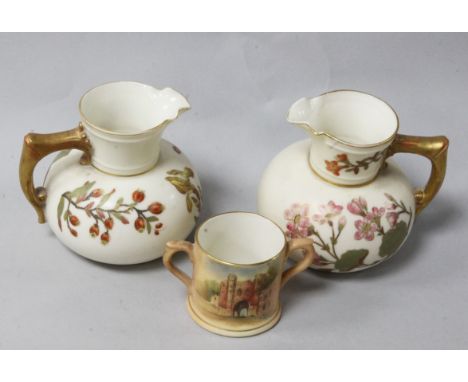 A pair of Royal Worcester blush ewers and a loving cup