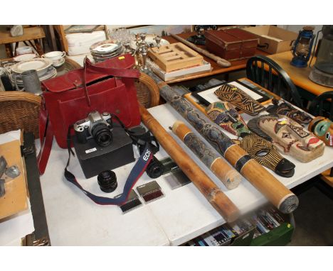 A Canon camera, various lenses, a carry bag and three rain sticks