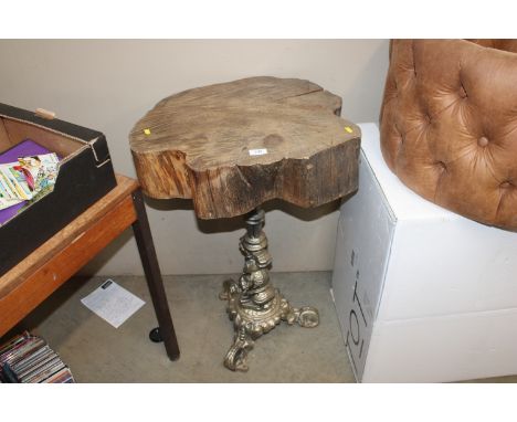 A wooden occasional table raised on ornate gilt tripod base