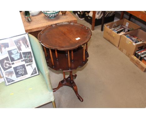 A mahogany revolving bookcase table raised on tripod base