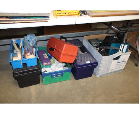 Four boxes containing various artists materials to include paint brushes, trays, a Panasonic camera, glue etc.