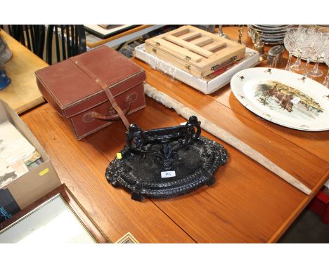 A cast iron boot scraper, an ethnic decorated walking stick and leather boules box